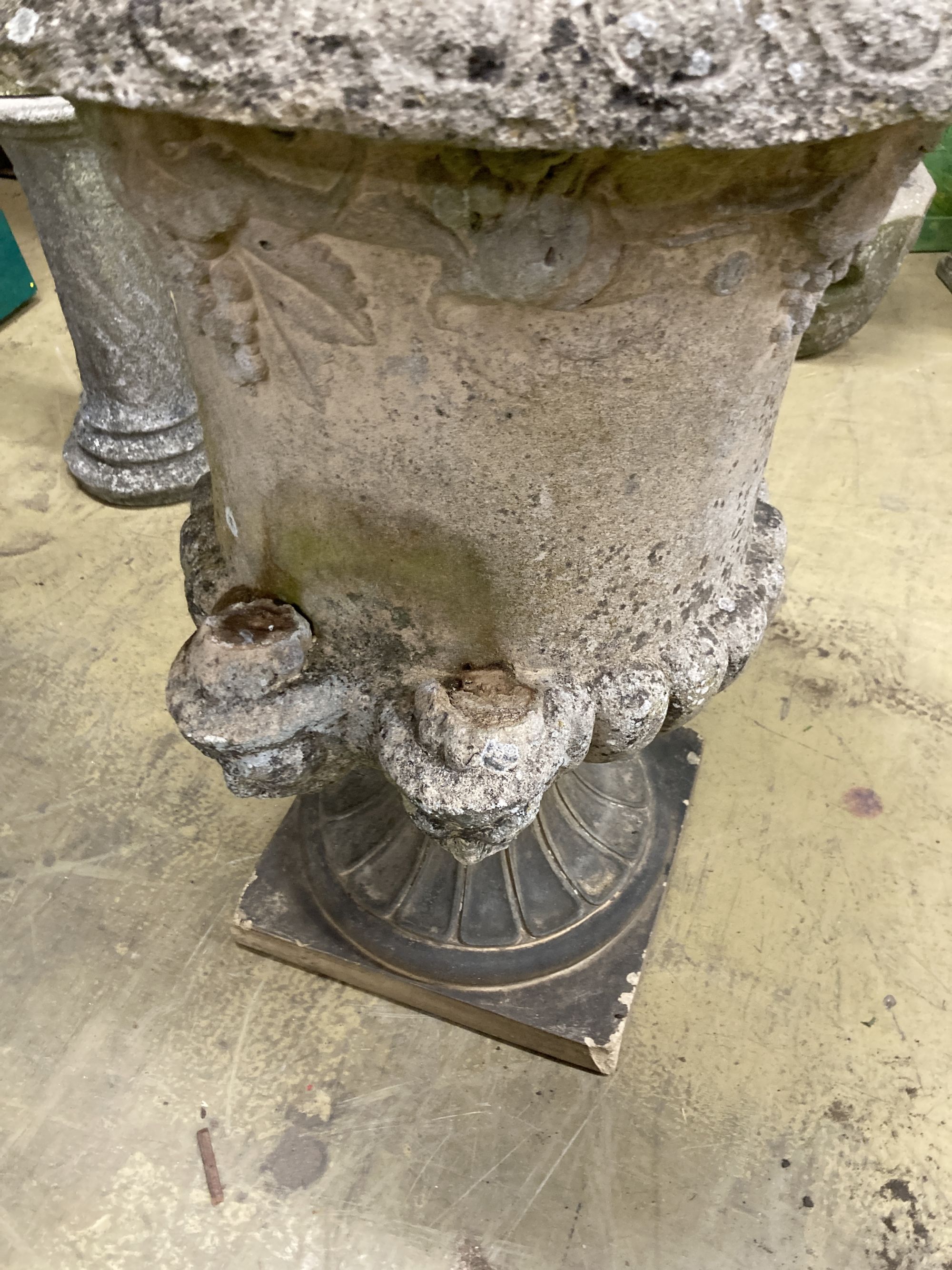 A large reconstituted stone campana garden urn, handles in need of repair, 75cm diameter, height 96cm